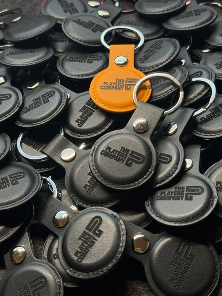 Custom branded leather AirTag holders for a company order