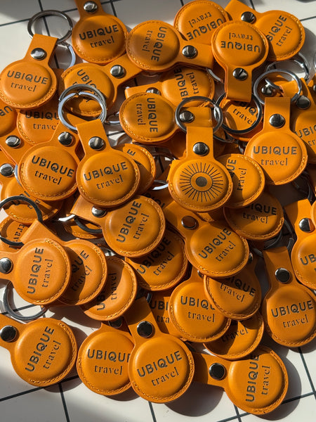 Logo engraved leather AirTag holders in a large corporate run
